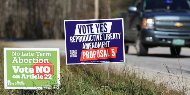 Opposing campaign signs supporting a proposed amendment to the Vermont constitution that would guarantee access to reproductive rights, including abortion, by the side of the road in on Nov. 3, 2022 in Middlesex, Vt.