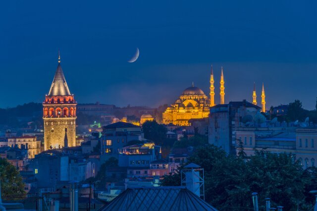 View of the Galata Tower and The Suleymaniye Mosque at dusk in Istanbul, Turkey
