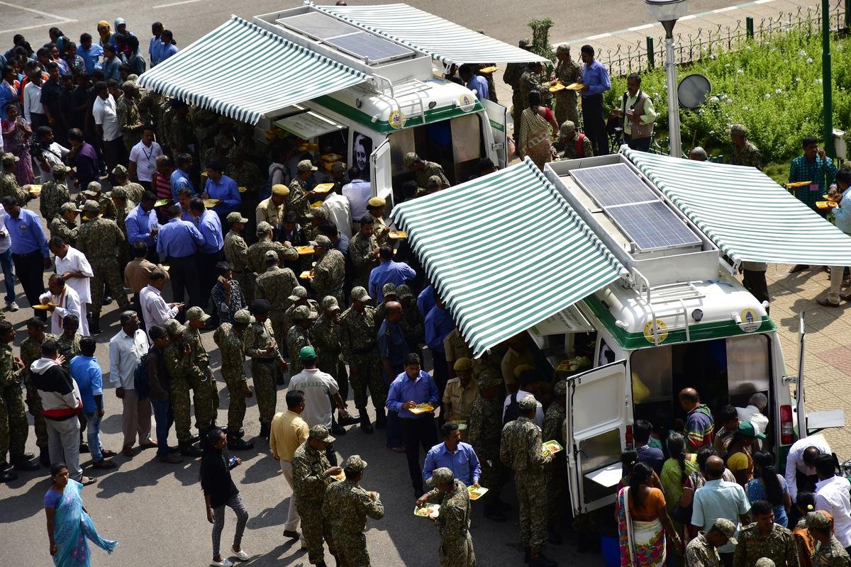 A file photo of people having food at the newly-inaugurated mobile Indira Canteen, at Vidhana Soudha in Bengaluru on January 26, 2018.  