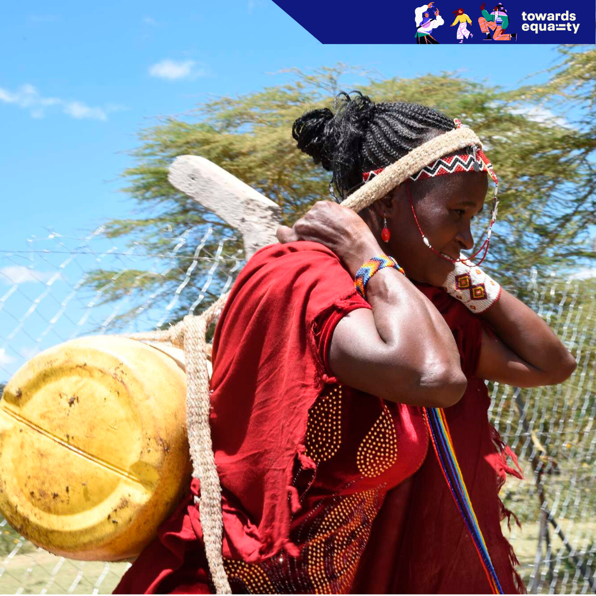 Veronica Leakono carrying a jerrican of water after fetching it at Loosuk watering point in Samburu County.
