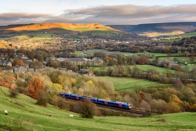 Passanger train passing through the British countryside near greater Manchester, England