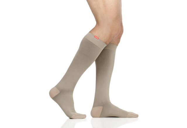 Shots of legs wearing VIM & VIGR's Moisture Wick Nylon Graduated Compression Socks in cashew against white background